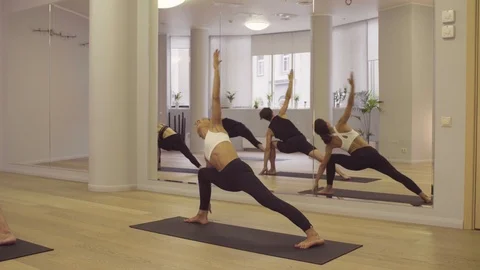 Yoga class People practicing yoga Side Angle Pose Stock Footage 88724640