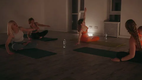 Yoga Class Stretching in Dimly Lit Studio Stock Footage 282602502