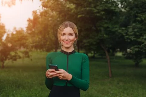 Yoga classes on the grass in the park using a mobile phone. Stock Photos