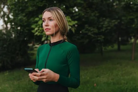Yoga classes on the grass in the park using a mobile phone. Stock Photos