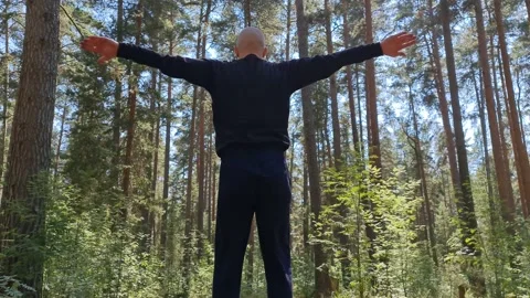 Yoga elements. A young man goes in for sports in the forest. Stock Footage 156958772