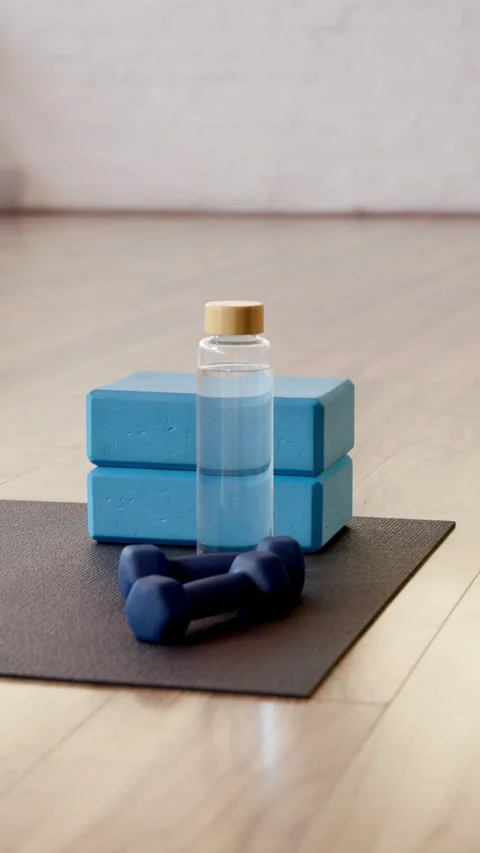 Yoga, empty and dumbbells in studio on floor for workout routine, exercise and Stock Footage 319392216