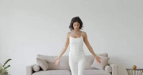 Yoga exercises, classes at home. Front view. A young woman in a white top 스톡 동영상 157950018