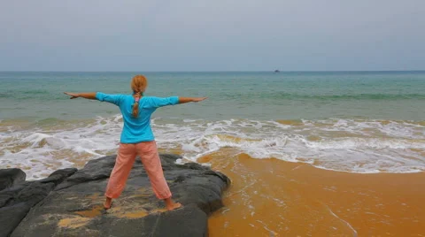 Yoga exercises by the ocean Stock Footage