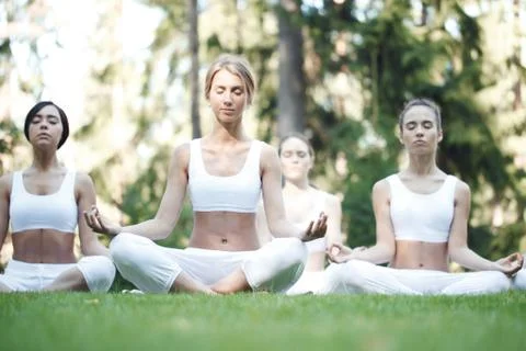 Yoga group training at park Stock Photos