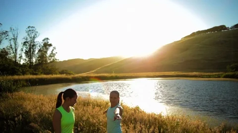 Yoga instructor assisting a student with a pose. Video stock 88404636