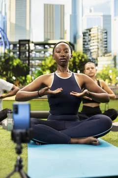 Yoga instructor demonstrating breathing exercise for smartphone video Fotos Stock