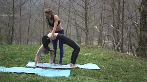 Yoga instructor explaining female how to do yoga pose Stock Footage 132037264