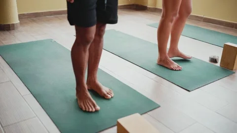 Yoga instructor guiding students through foot and ankle strengthening exercises 動画素材 345153817
