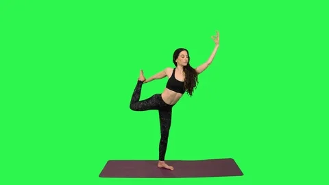 Yoga Instructor practices a series of positions over green screen. Stock Footage