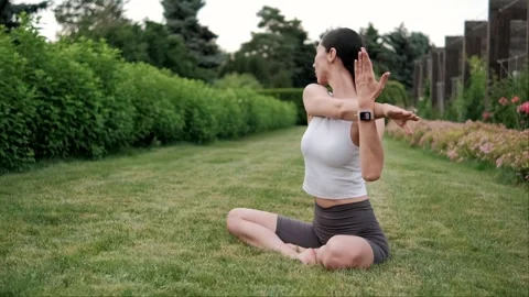 Yoga instructor practicing various asanas outdoors in a park, embracing nature Stock Footage 294898650