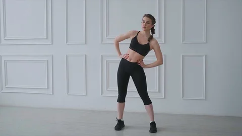 Yoga instructor shows the exercises with the tilt of the body in the side. Stock Footage 128188490