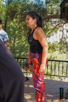 Yoga Instructor Teaching Mindfulness Workshop Near Large Pine Tree Outdoors. Stock Photos