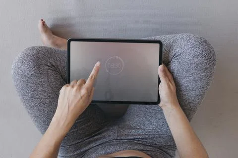Yoga instructor using a digital tablet mobile phone wallpaper Stock Photos