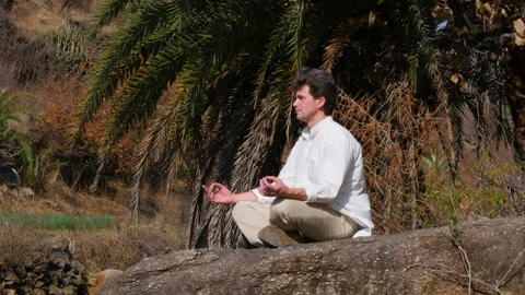 A yoga man does meditation on a bridge Stock-Footage 239653020