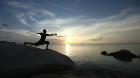 Yoga: Man Performing Warrior Pose By The Sea Video stock 25946373