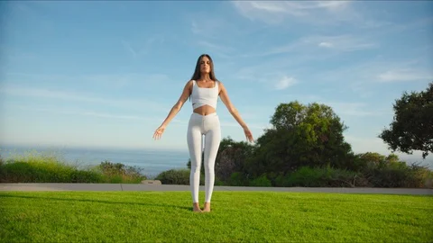 Yoga master doing yoga session at park with view on an ocean Stock Footage 129998379