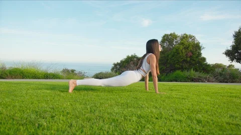 Yoga master doing yoga session at park with view on an ocean Stock Footage 129998535
