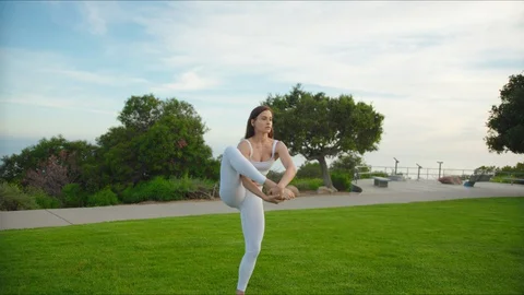 Yoga master doing yoga session at park with view on an ocean Stock Footage 129998617