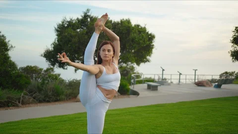 Yoga master doing yoga session at park with view on an ocean Stock Footage 129998745