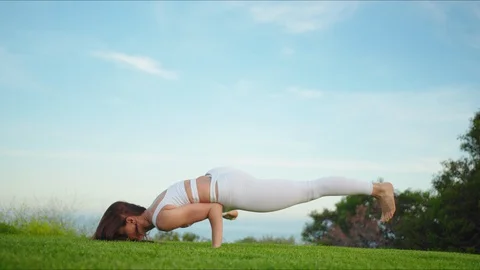 Yoga master doing yoga session at park with view on an ocean Stock Footage 129998888