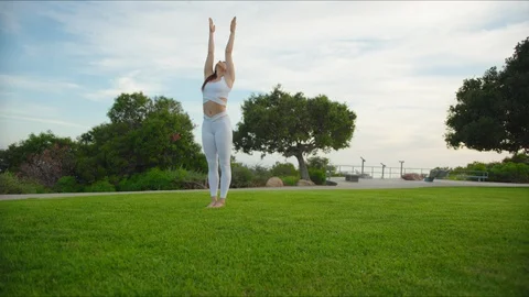 Yoga master doing yoga session at park with view on an ocean Stock Footage 129998919