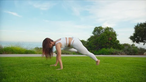 Yoga master doing yoga session at park with view on an ocean Stock Footage 129998937