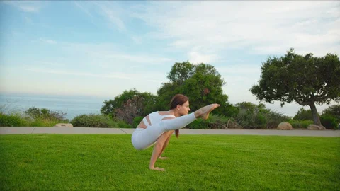 Yoga master doing yoga session at park with view on an ocean Stock Footage 129999067