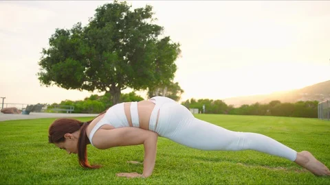 Yoga master doing yoga session at park, backlit sunlight Stock Footage 129999350