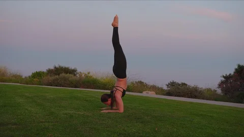 Yoga master doing yoga session at park, beautiful sunset Stock Footage 129999647