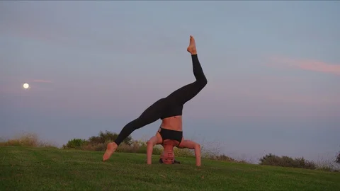 Yoga master doing yoga session at park, beautiful sunset Stock Footage 129999677