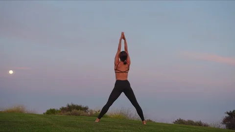 Yoga master doing yoga session at park, beautiful sunset Stock Footage 129999726