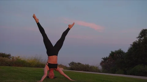 Yoga master doing yoga session at park, beautiful sunset Stock Footage 129999734