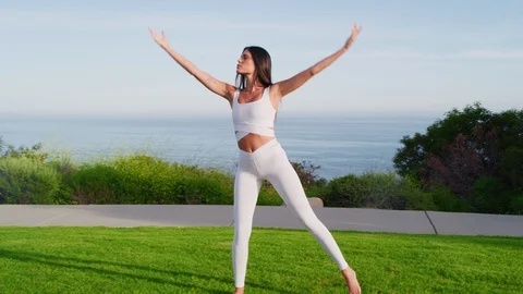 Yoga master doing yoga session at park with view on an ocean Stock Footage 130044029
