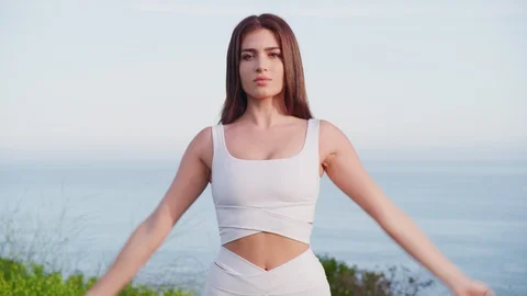 Yoga master doing yoga session at park with view on an ocean Stock Footage 130044175