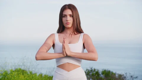 Yoga master doing yoga session at park with view on an ocean Stock Footage 130044191