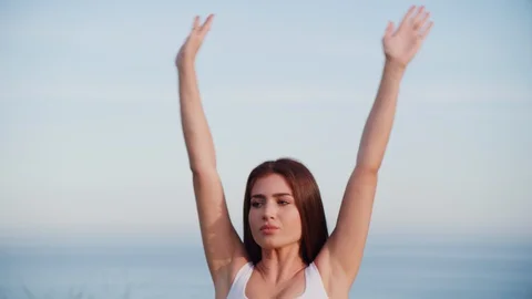 Yoga master doing yoga session at park with view on an ocean Stock Footage 130044289