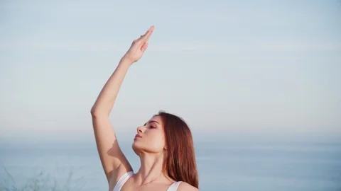 Yoga master doing yoga session at park with view on an ocean Stock Footage 130044355