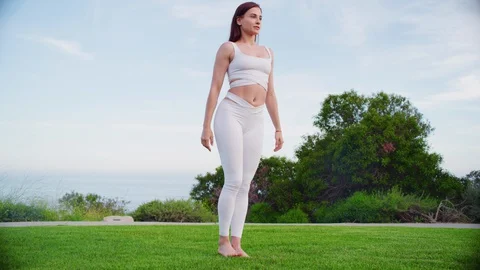 Yoga master doing yoga session at park with view on an ocean Video stock 130047218