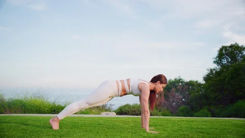 Yoga master doing yoga session at park with view on an ocean Video stock 130049201