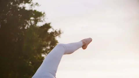 Yoga master doing yoga session at park, backlit sunlight Video stock 130049654