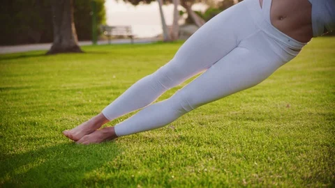 Yoga master doing yoga session at park, backlit sunlight Stock Footage 130049688