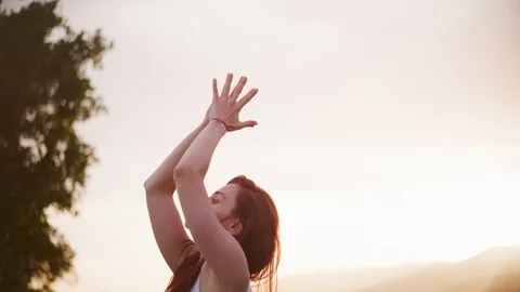 Yoga master doing yoga session at park, backlit sunlight Stock Footage 130050732