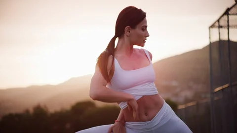 Yoga master doing yoga session at park, backlit sunlight Stock Footage 130051144