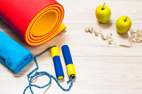 Yoga mat and different tools for fitness on floor in room. Foto stock