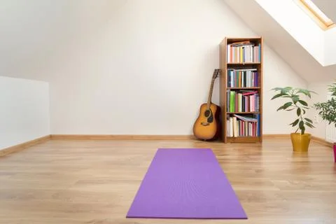 Yoga mat in empty loft room interior Stock Photos