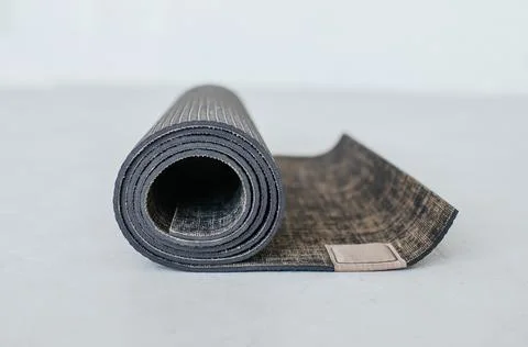 Yoga mat on a light background. Place for your text. Stock Photos
