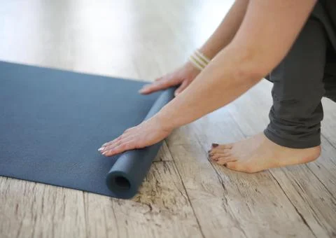 Yoga mat rolling up Stock Photos