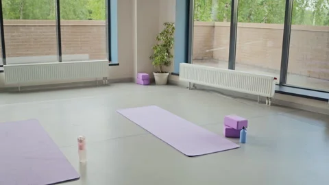Yoga Mats with Blocks Prepared for Class in Empty Wellness Studio Stock Footage 339845211