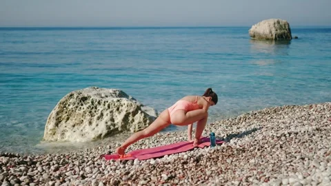 Yoga Practice on the Beach, Surrounded by a Scenic Ocean View Video stock 283077181
